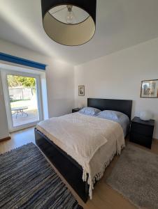 a bedroom with a large bed and a large window at Casa da Mata in Paredes de Coura +48 photos