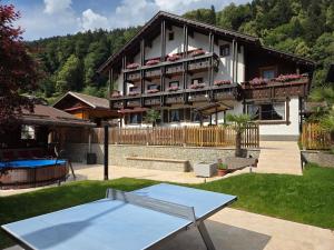 a house with a tennis court in the yard at Pension Monteneu in Bartholomäberg
