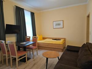a small living room with a couch and a table at Pension am Elberadweg in Radebeul