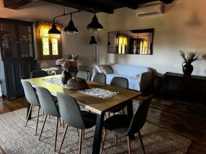 a dining room with a table and chairs and a bed at Čardak Mraclin in Mraclin +35 photos