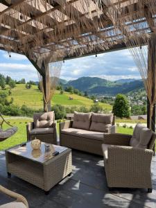 a patio with couches and chairs and a table at Sadova Loft View in Sadova