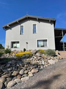 a house with a rock garden in front of a house at Apartmány Branná hodnocení 10 Wellness Vleky 5 min in Horní Branná