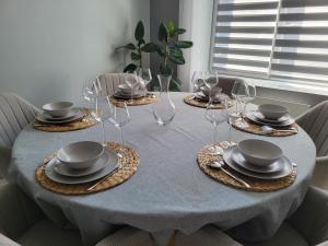 a dining room table with plates and wine glasses at Loéli's House in Tourcoing +66 photos