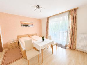 a bedroom with a bed and a table and a window at Feistritzer in Seeboden