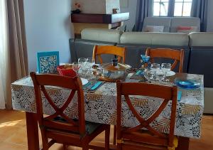 a dining room table with a table cloth with glasses on it at Ilodays in La Plaine des Cafres +8 photos