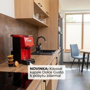 a kitchen with a red coffee machine on a counter at Bungalov u Draka Vřesina in Vřesina +13 photos