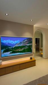 a large flat screen tv on a wall at Modern 2BR Apartment in Khafji in Khafji