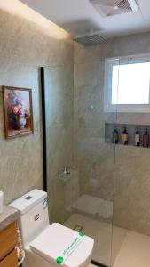a bathroom with a glass shower with a toilet at Modern 2BR Apartment in Khafji in Khafji