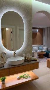 a bathroom with a sink and a large mirror at Modern 2BR Apartment in Khafji in Khafji