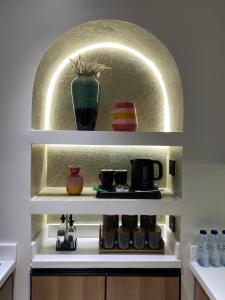 a shelf with a vase and other items on it at Modern 2BR Apartment in Khafji in Khafji +11 photos
