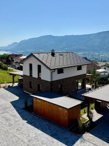 a house with a roof on top of a patio at Landhaus Steinrose in Bodensdorf