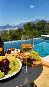 a glass of wine sitting next to a plate of food at Alta Vista House in Bar