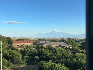 a view of a town with mountains in the background at Sargis guest house in Ushi