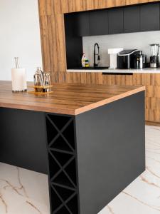 a kitchen island with a wooden counter top at Villa La Reina in Bar