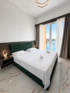 a bedroom with a large bed with a large window at Villa La Reina in Bar