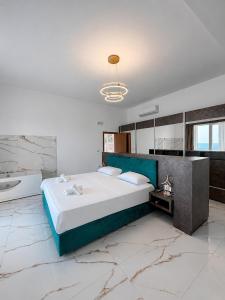 a bedroom with a large bed and a bathroom at Villa La Reina in Bar +19 photos