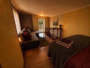 a living room with a couch and a table at Cenkones Bungalow in Cenkoņi