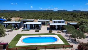 an aerial view of a house with a swimming pool at Mobile Homes Albatross in Pirovac