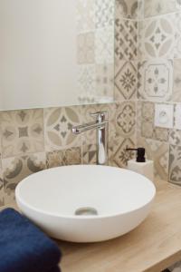 a white sink on a wooden counter in a bathroom at LA DOLOREANNE in Saint-Didier-sur-Chalaronne +18 photos