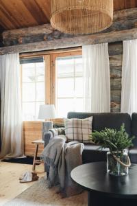 a living room with a couch and a table at Kelo Naava in Ruka