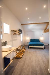 a bedroom with a bed and a sink at LA DOLOREANNE in Saint-Didier-sur-Chalaronne