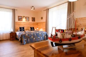 a room with a bed and a toy boat in it at Ostoja Dwa Jeziora in Węgorzewo