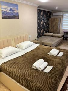 a bedroom with two beds with towels on them at Kapan Guesthouse in Kapan