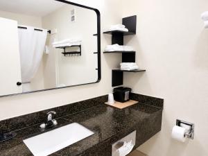 a bathroom with a sink and a mirror at Quality Inn Harrodsburg in Harrodsburg