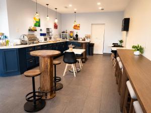 a kitchen with blue cabinets and bar stools at Quality Inn Harrodsburg in Harrodsburg