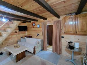 a living room in a log cabin with a couch and a table at Beco's Place in Plav