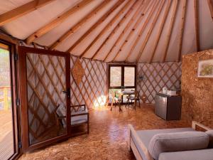 a room with a tent with a couch and a table at Salema Eco Camp - Sustainable Camping & Glamping in Salema
