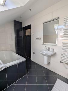 a bathroom with a tub and a sink and a mirror at Ostań i Odpocznij Podzamcze in Podzamcze +51 photos