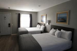 a hotel room with two beds and a couch at Aquastar Inn in Westerly +47 photos