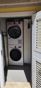 a washer and dryer in a small room at TinaToni Apartment in Follonica