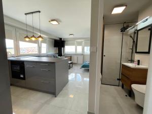 a large bathroom with a sink and a toilet at ComeWa Apartments in Warsaw +196 photos