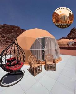 a dome tent with chairs and a swing at camp sand in Disah +9 photos