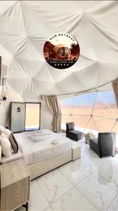 a bedroom with a large bed in a tent at camp sand in Disah