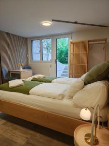 a large bedroom with a large bed in a room at O&D Guest Room in Flurlingen