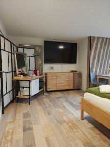 a bedroom with a large flat screen tv on the wall at O&D Guest Room in Flurlingen
