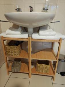 a bathroom with a sink and baskets under it at O&D Guest Room in Flurlingen +40 photos