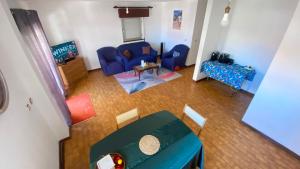 an overhead view of a living room with a blue couch at Daboussi Home in Apúlia