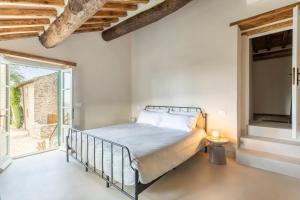 a bedroom with a bed and a large window at Relais Tosca in Cortona +73 photos