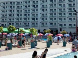 a group of people on the beach near a building at Vivo in Jagodina