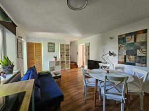 a living room with a table and a blue couch at Oaza Spokoju in Gdynia