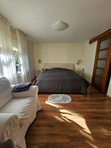 a bedroom with a bed and a couch at Oaza Spokoju in Gdynia