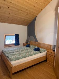 a bedroom with a large bed in a room at Casa Seler - Appartamento verde in Predazzo