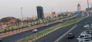 a highway with cars driving on it in a city at المها إن للشقق المخدومة in Hail