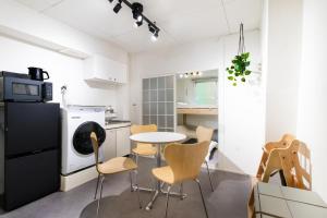 a kitchen with a table and chairs in a room at Epilogue Hotel 202 in Fukuoka +15 photos