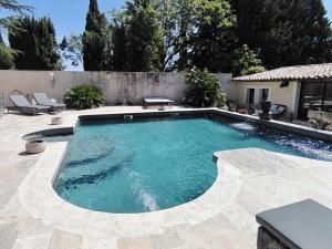 a large swimming pool in a yard with a patio at Le Mas Paolo in Le Thor +22 photos