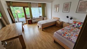 a bedroom with two beds and a table and a desk at Wohnung in Datteln in Datteln